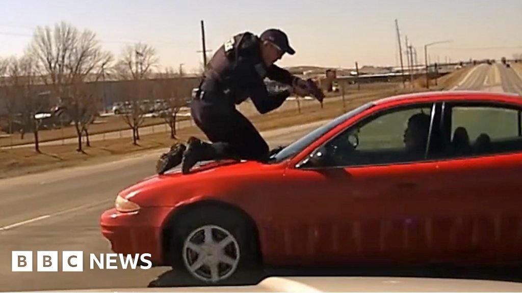 Watch: Officer clings to speeding car in wild chase