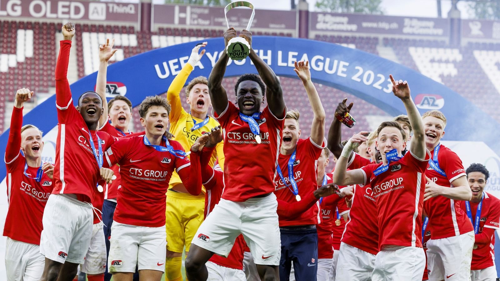 AZ Alkmaar's Ernest Poku celebrates with his teammates and the Youth League trophy after the Youth League final soccer match between AZ Alkmaar and HNK Hajduk Split at the Stade de Geneve stadium, in Geneva, Switzerland, Monday, April 24, 2023.