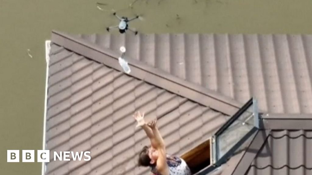 Ukraine drops water bottles to people stranded by floods