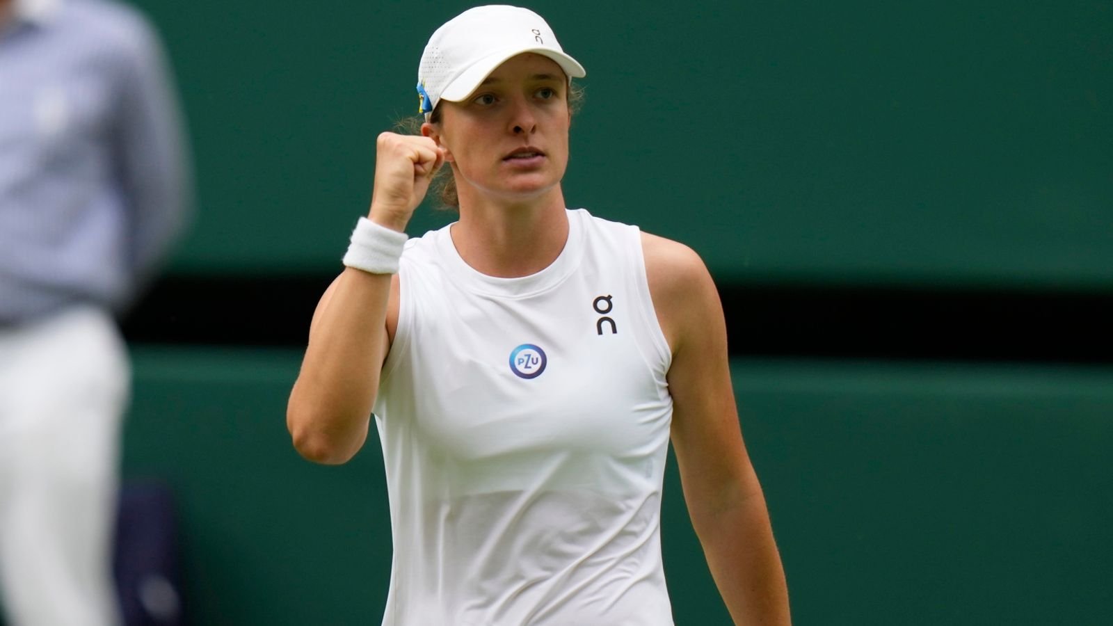 Poland's Iga Swiatek celebrates defeating Spain's Sara Sorribes Tormo during the women's singles match on day three of the Wimbledon tennis championships in London, Wednesday, July 5, 2023. (AP Photo/Alastair Grant)
